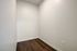 Cozy nook with elegant wood flooring and soft neutral walls, ideal for creative customizations or storage solutions.