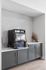 Modern kitchen nook with sleek gray cabinetry, stylish tile backsplash, and beverage dispenser for convenience.