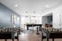 Modern recreational room with sleek foosball tables, stylish decor, and ample natural light.