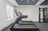 Modern fitness room with high-tech treadmills and versatile strength training equipment, flooded with natural light.