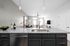 Modern kitchen with sleek granite countertops, featuring an inviting open-concept living area with stylish decor and natural light.