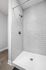 Sleek modern shower with elegant subway tiles, enhancing a luxurious bathroom ambiance.