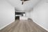 Elegant open-concept living area with modern kitchen, stylish cabinetry, and sleek wood flooring.