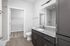 Sleek bathroom with granite countertop, modern fixtures, and spacious walk-in closet, offering contemporary living style.