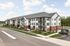 Modern apartment complex with elegant architecture, featuring spacious balconies and surrounded by lush greenery and a serene road view.