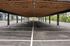Spacious covered parking area with modern design offering protection and convenience for residents.
