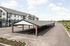Modern apartment complex with charming covered parking, ample spaces, and lush surroundings.