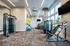 Modern fitness center with state-of-the-art gym equipment, large windows for natural light, and vibrant exercise balls.