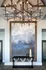 Elegant entryway with modern geometric chandelier, abstract wall art, and chic console table creating a welcoming atmosphere.