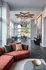Luxurious open-concept living space featuring a modern chandelier, elegant seating, and floor-to-ceiling windows offering scenic outdoor views.