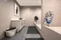 Modern laundry room featuring sleek cabinetry, stylish wall art, and a convenient pet washing station.