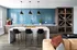 Contemporary kitchen featuring a chic blue backsplash, sleek modern lighting, and a stylish island with bar seating, perfect for entertaining.