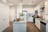Modern kitchen with sleek stainless steel appliances, granite countertops, stylish cabinetry, and elegant lighting fixtures.