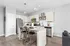 Sleek modern kitchen with granite countertops, stainless steel appliances, and elegant pendant lighting.