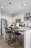 Modern kitchen with sleek stainless steel appliances, chic pendant lighting, and stylish granite countertops, accented by vibrant floral decor.