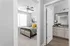 Modern apartment view featuring a cozy bedroom with stylish decor and an adjacent bathroom showcasing sleek cabinetry and granite countertops.