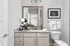 Modern bathroom with elegant granite countertop, sleek vanity, and stylish wall art, offering a luxurious and inviting ambiance.