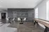 Modern communal space with stylish partition, sleek tables, and a shuffleboard game, perfect for socializing and relaxation.