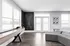 Contemporary living room with sleek seating, chic wall art, and natural light streaming through large windows.