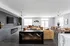 Modern open-concept living space with stylish decor, featuring a cozy fireplace, elegant lighting, and ample seating.