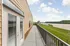 Inviting apartment balcony with stunning river views, perfect for relaxation and enjoying nature.