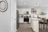 Modern kitchen with stylish cabinetry, stainless steel appliances, and a chic island counter, enhanced by natural light and elegant decor.