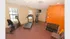 Bright and modern home gym featuring a treadmill, stationary bike, elliptical, and a set of free weights, perfect for a convenient workout experience.