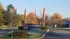 Inviting entrance to The Brixton Apartments adorned with vibrant flags and surrounded by lush greenery, offering a welcoming community atmosphere.