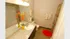 Bright and inviting bathroom with modern granite countertop, vibrant decor, and sleek wood flooring.
