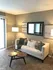 Chic living room with plush sofa, stylish cushions, and modern decor, featuring warm lighting and a cozy ambiance.