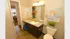 Contemporary bathroom with elegant granite countertop, modern fixtures, and artistic decor.