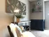 Chic and cozy living space featuring elegant geometric wall art, a stylish metal lamp, and a sleek fireplace corner adorned with modern decor.