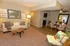 Inviting living room with cozy seating, elegant decor, and natural lighting leading to a stylish dining area with modern charm.