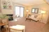Cozy living room with elegant decor, featuring a plush sofa, stylish coffee table, and abundant natural light through large sliding doors.