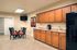 Inviting kitchen space with elegant wooden cabinets, modern appliances, and cozy dining area.