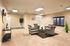 Elegant lounge area featuring chic armchairs, modern decor, lush indoor plant, and warm lighting, ideal for relaxation and social gatherings.