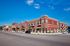 Charming urban apartment complex with stylish brick facade and modern design, offering vibrant street views and ample natural light.