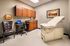 Modern medical examination room with a comfortable exam table, sleek cabinetry, and a patient-friendly ambiance.