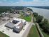 Charming aerial view of a modern apartment complex with scenic riverside location, spacious parking, and beautiful greenery in a vibrant community.