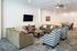 Inviting living room with comfortable seating, modern decor, and wall-mounted TV, perfect for relaxation and entertaining.
