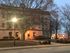 Charming historic building at dusk with warm glowing streetlights and a serene urban ambiance.