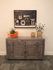 Charming wooden sideboard with vintage camera artwork and elegant decor pieces, creating a warm and inviting entryway.