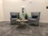 Cozy seating area with stylish checkered armchairs, modern decor, and a chic round coffee table.