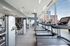 Modern gym with sleek cardio machines and strength training equipment, offering panoramic views of the city skyline through floor-to-ceiling windows.
