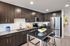 Modern kitchen with sleek dark cabinetry, stainless steel appliances, and an elegant island centerpiece.