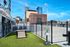 Rooftop dog park with agility equipment and stunning city skyline views, perfect for pet-friendly living.