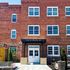 Charming brick facade of Pearl Street Apartments with inviting entrance and large windows at 315 E Pearl St, offering stylish two-bedroom living spaces.