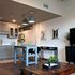 Contemporary open-plan kitchen and living area with sleek cabinetry, elegant pendant lighting, and stylish decor.