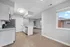 Modern kitchen with sleek cabinetry, granite countertops, and stainless steel appliances in a bright, open-concept apartment.