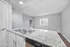 Modern kitchen with sleek granite countertops, dual sink, and bright natural light creating a welcoming and functional space.